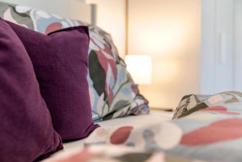 a bed with purple pillows and a purple pillow at Ferienwohnung Sophia Inzell - Neu in Inzell