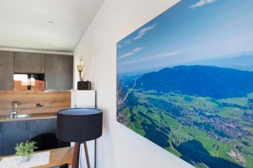 a kitchen with a painting hanging on the wall at Ferienwohnung Sophia Inzell - Neu in Inzell