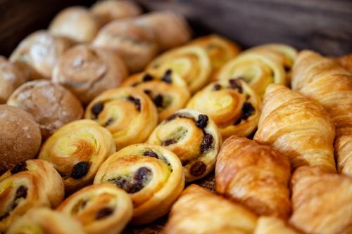 a pile of pastries and croissants on a table at ANA Holiday Inn Iwate Kitakami by IHG in Kitakami