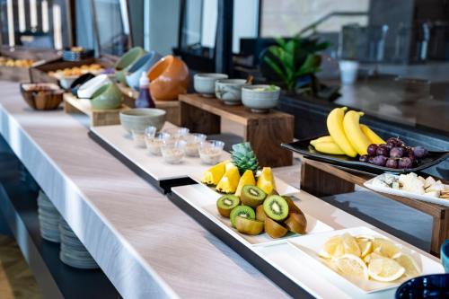 a buffet line with different types of fruit on plates at ANA Holiday Inn Iwate Kitakami by IHG in Kitakami