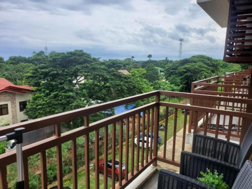 a balcony with a view of the forest at VERDANT by Vista Manors Deluxe Rooms with Balcony, Gym and Swimming Pool in Puerto Princesa City