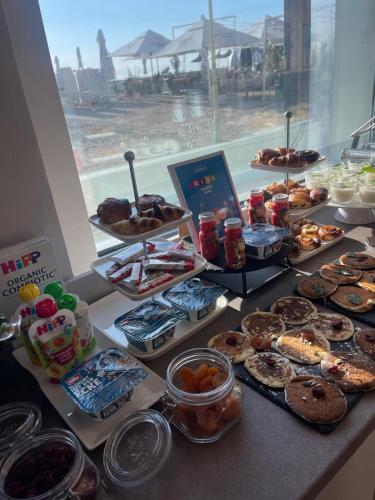 a table with a bunch of different types of pastries at Hotel Hawaii in Mamaia