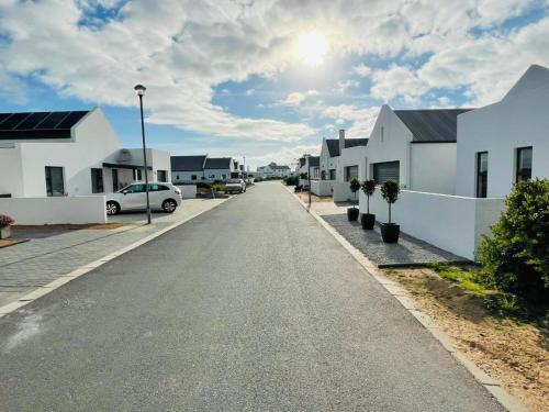 an empty street in a residential neighborhood with houses at 44 Staycation Beach-house in Britannia Bay
