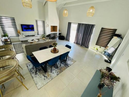 a large living room with a table and chairs at 44 Staycation Beach-house in Britannia Bay