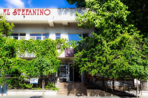 an office building with trees in front of it at ElStefanino House in Eforie Nord