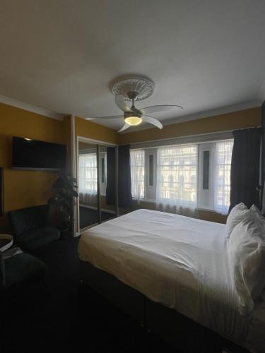 a bedroom with a large white bed and a window at The Montana in Torquay
