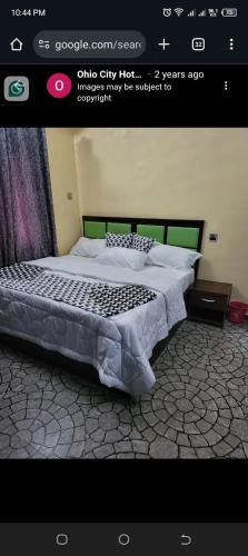 a bedroom with a large bed in a room at Ohio city hotel in Owerri