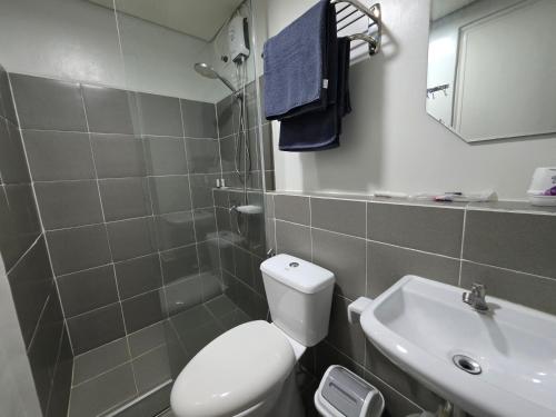 a bathroom with a toilet and a sink at VERDANT by Vista Manors Deluxe Rooms with Balcony, Gym and Swimming Pool in Puerto Princesa City