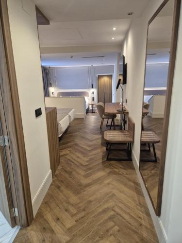 a room with a bed and a table and a bedroom at Silken Rona Dalba in Salamanca