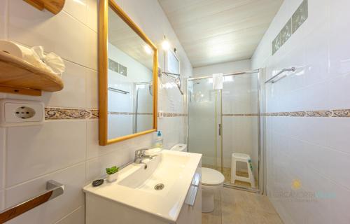 a white bathroom with a sink and a shower at Casa Luna a 700m de la playa en puerto Alcudia in Port d'Alcudia