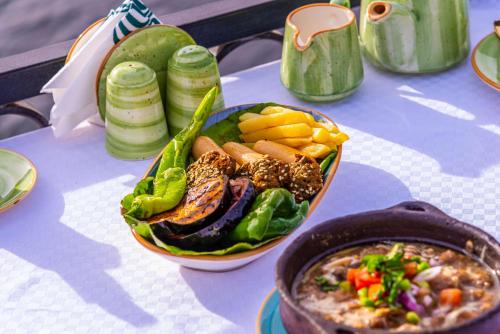 a table with a bowl of food and a bowl of soup at Sonesta Nouba Hotel Aswan in Aswan