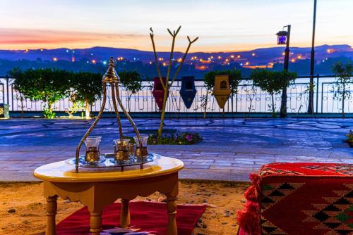 a table with a group of candles on it at Sonesta Nouba Hotel Aswan in Aswan