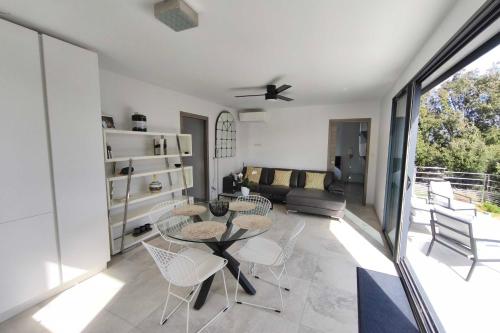 a living room with a table and chairs at Apartment 3 rooms with garden in Ajaccio in Ajaccio