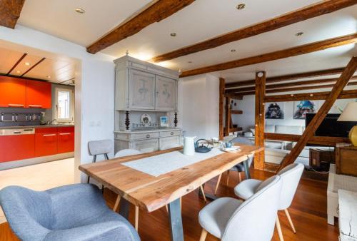 a kitchen with a wooden table and some chairs at Maison alsacienne 2-5 pers au centre d'Obernai in Obernai