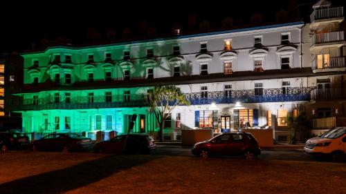 a white building with green lights on it at The Southcliff Hotel in Folkestone