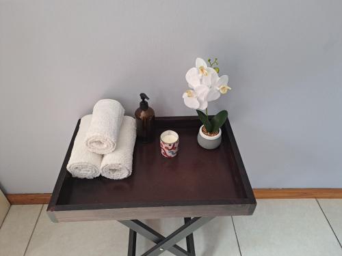a wooden table with towels and flowers on it at Palmetto guesthouse in Mahikeng