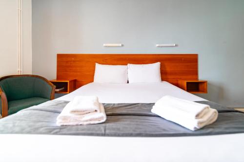 a bedroom with a bed with two towels on it at The Southcliff Hotel in Folkestone