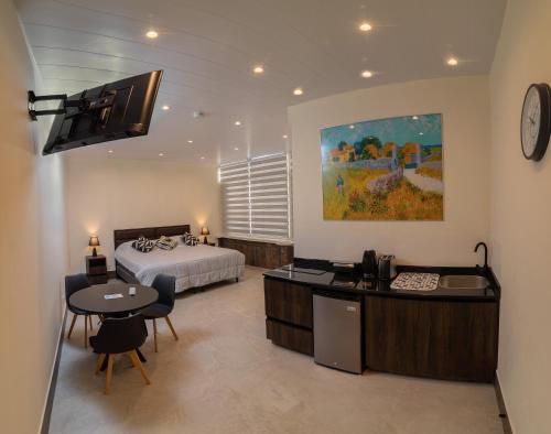 a hotel room with a bed and a table and chairs at Kawsay Apart in La Paz