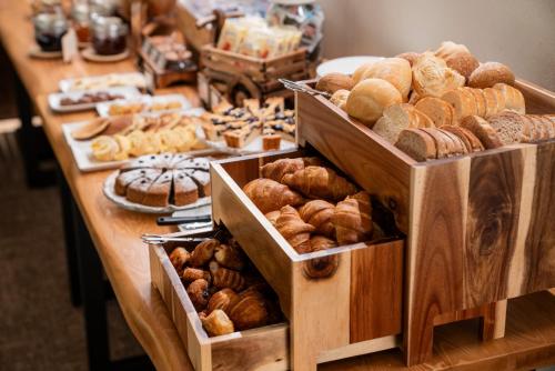 a table filled with lots of different types of pastries at Residence Lastei in San Martino di Castrozza