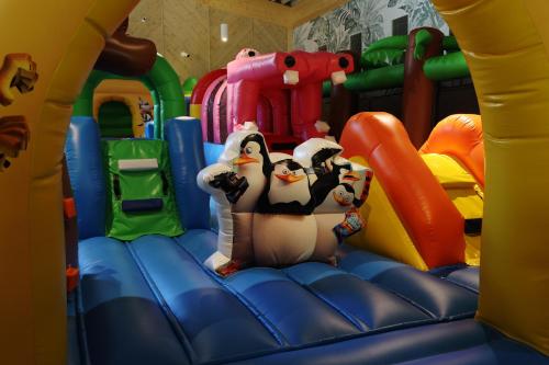 a group of penguins on a inflatable slide in a playground at Aries Hotel & SPA Szczyrk in Szczyrk