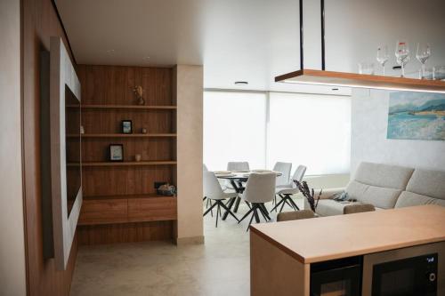 a kitchen and living room with a table and chairs at Sucro Playa Apartment in Cullera