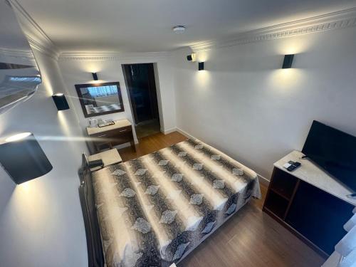a small room with a bed and a television at Hanedan Hotel in Istanbul