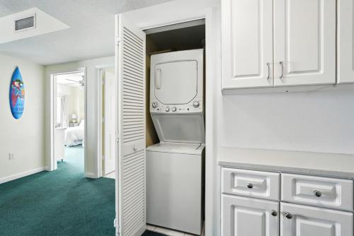 a kitchen with a washer and dryer in a closet at *New Listing* Breathtaking 2BR condo with 2 Private Oceanview Balconys at Wyndham Ocean Walk Resort in Daytona Beach