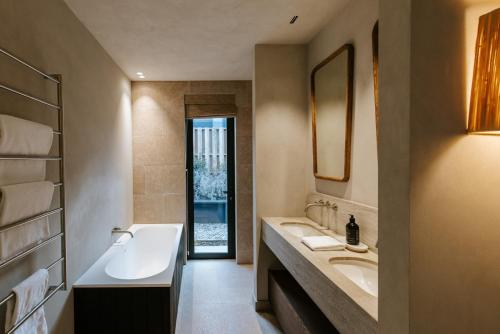 a bathroom with two sinks and a large mirror at Riverslea in Wanaka