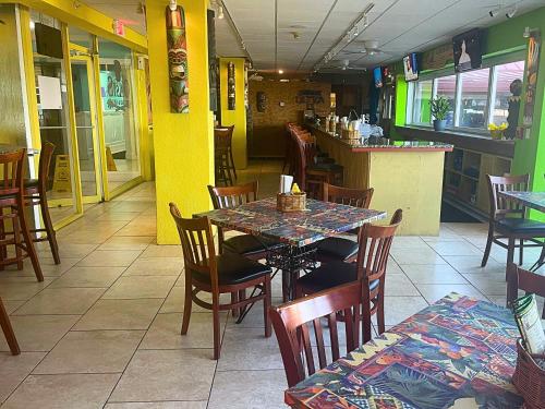 a dining room with a table and chairs in a restaurant at The Salty Fountain in Seabreeze