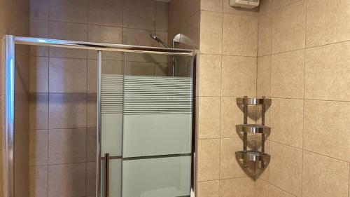a shower with a glass door in a bathroom at Crystal Coast Al Raha Village in Aqaba
