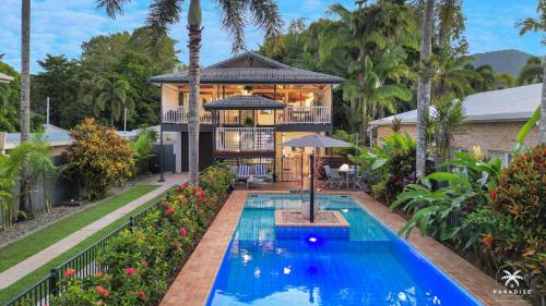 a house with a swimming pool in front of a house at The Arlington Beachfront House in Clifton Beach