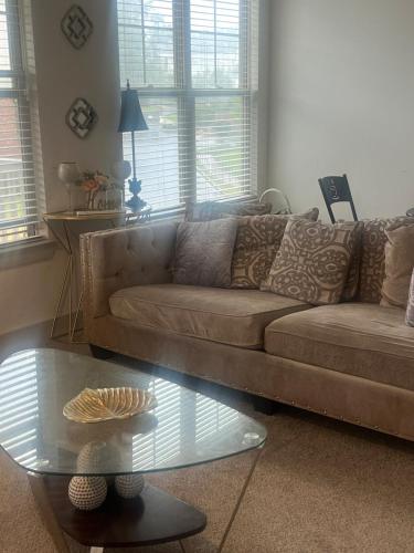 a living room with a couch and a glass table at Cozy Apartment Entire private 2bd 2ba in Canton