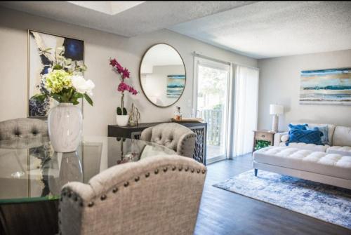 a living room with a couch and a mirror at The Reserve at Irondale in Birmingham