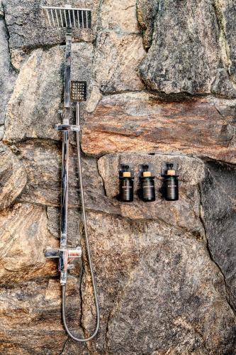 a shower in a rock wall with four black cameras at woodland sanctuary in Habarana