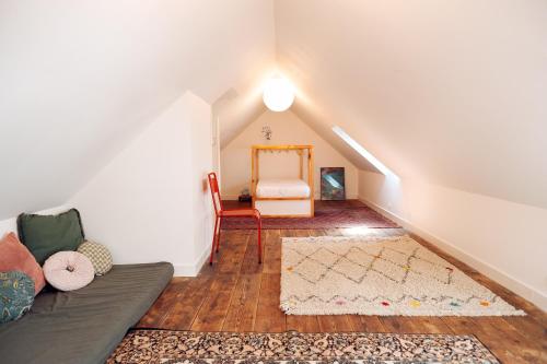 a living room with a couch and a rug at Vacances à l'école ! in Cléden-Cap-Sizun
