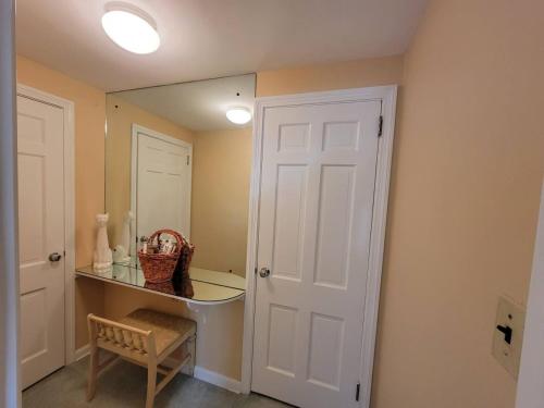 a bathroom with a mirror and a white door at Your Home Away from Home Sleeps 12 Fully Equipped in Youngstown