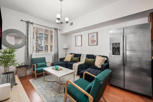 a living room with a couch and a table at New Modern Apt in Chinatown Parking Available in Philadelphia