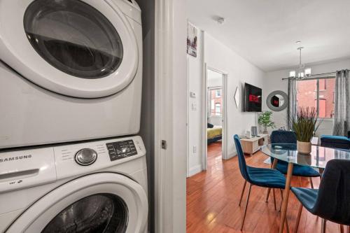 a living room with a washing machine and a dining room at New Modern Apt in Chinatown Parking Available in Philadelphia
