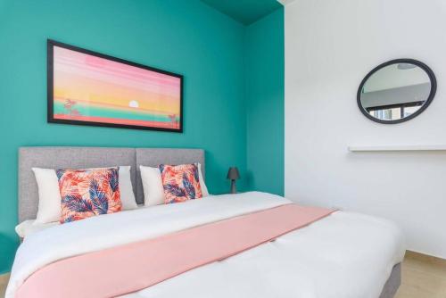 a bedroom with a bed with a large screen at Polka 2BR Apartment & Balcony in Batroun 