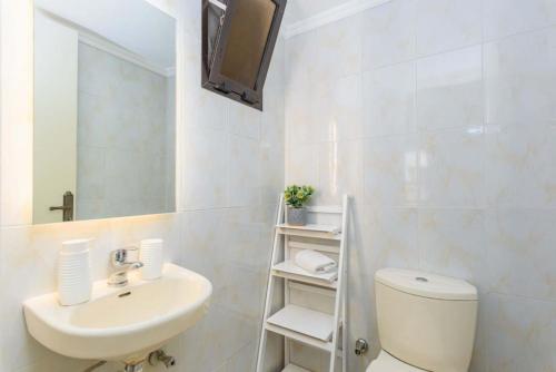 a bathroom with a sink and a toilet and a mirror at Polka 2BR Apartment & Balcony in Batroun 