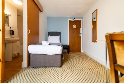 a small room with a bed and a bathroom at The Southcliff Hotel in Folkestone