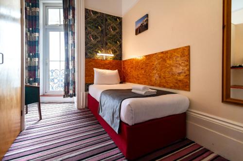 a hotel room with two beds and a window at The Southcliff Hotel in Folkestone