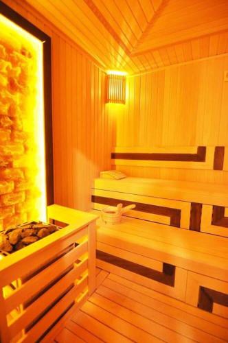 a sauna with a bench and a tub in it at Lovely Modern 1bd Condo Views W Poolgym! #222 in Istanbul