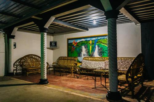 a room with chairs and a painting on the wall at la colonia 25 de mayo in Peña Blanca