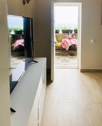 a living room with a tv on top of a dresser at ElStefanino House in Eforie Nord