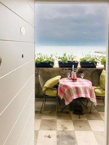 a table with two chairs and a table with glasses on it at ElStefanino House in Eforie Nord