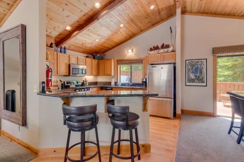 a kitchen with a counter and two bar stools at Modern 3BR Tahoe Cabin with Hot Tub in Tahoe City