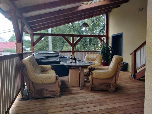 a patio with a table and chairs on a deck at Elements Apartments & Renata in Božičany