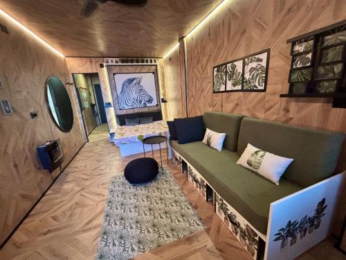 sala de estar con sofá verde y alfombra en Farnals Playa Valencia, en Masalfasar