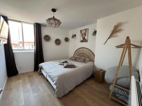 a bedroom with a bed and a large window at Oasis Africaine in Lens